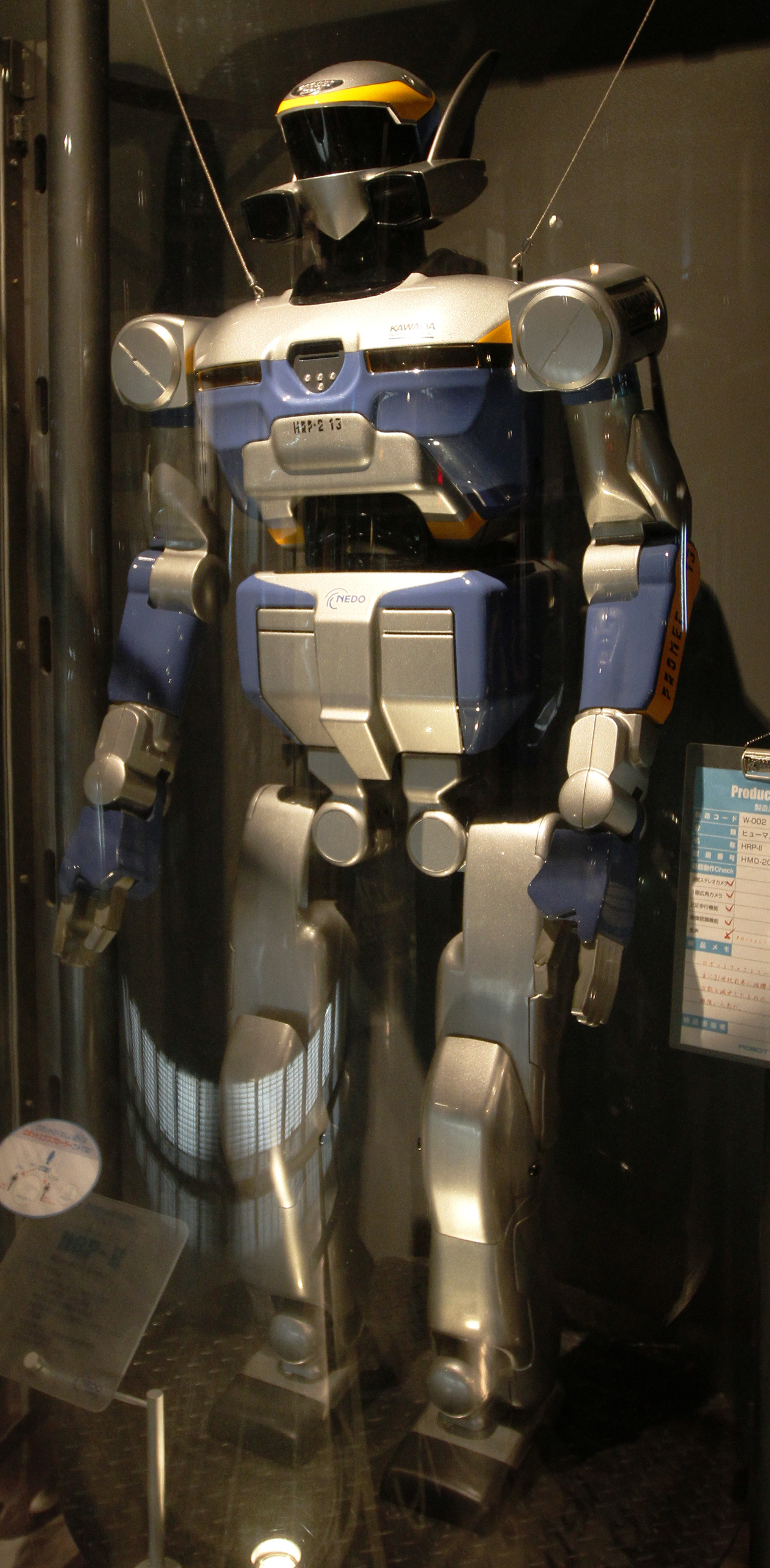 Figure 1.4: AIST HRP-2 (2002–2005) — the flagship of Japan's national Humanoid Robotics Project, the first production-class body to carry the Kajita-group control stack. — source: Wikimedia Commons (CC BY), fair use for academic review